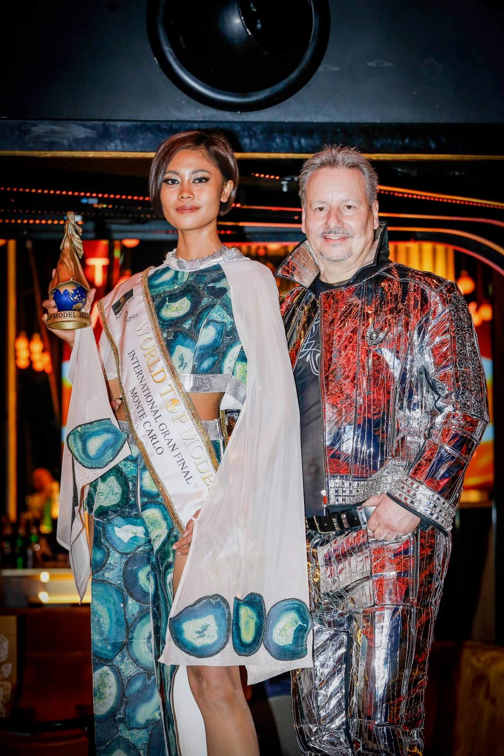 Toni Hamler with the World Top Model International winner in Monte Carlo, showcasing his exclusive wallpaper fashion designs that blend art, luxury, and haute couture.