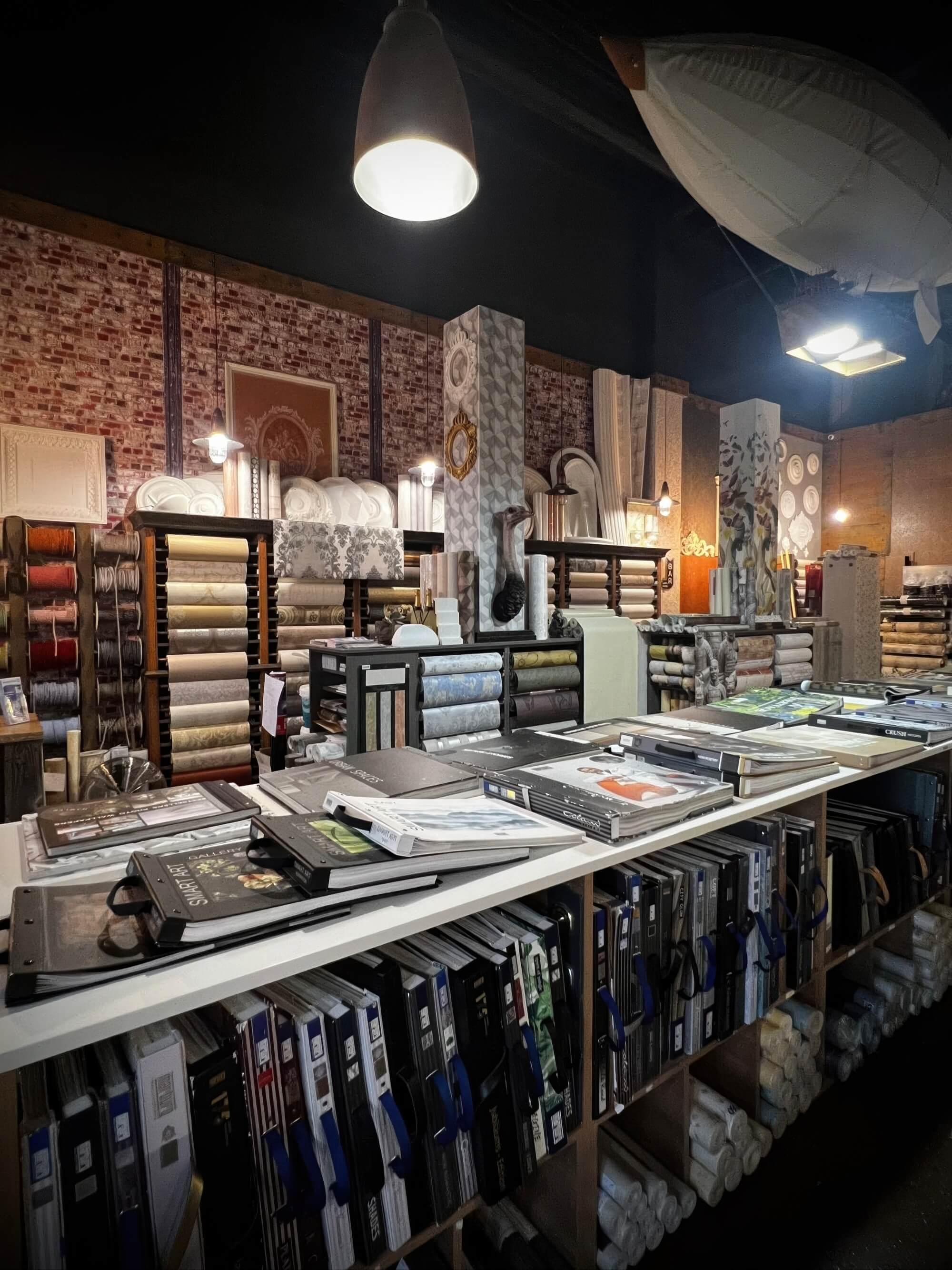 A wide-angle view of a premium wallpaper shop featuring various wallpaper textures, styles, and designs.